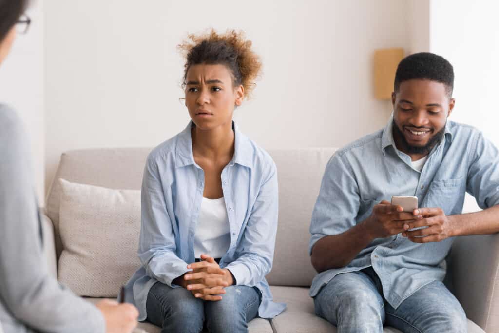 Husband Playing Phone While Visiting Couples Therapy With Wife